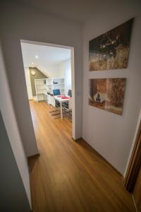 a hallway with a dining room and a dining table at Apartamenty Leśna in Limanowa