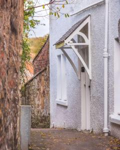 a building with a white window on the side of it at Poppy's Place Cupar in Cupar