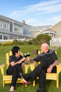 a man and a woman sitting on a bench at Dundee Resort & Golf Club in West Bay
