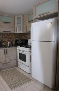 a kitchen with a white refrigerator and a stove at Apartments Pepe's VIEW - A in Aguada