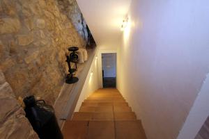 a hallway with a stone wall and a stairway at Laguardia -Casa Páganos E VI 0114 in Páganos