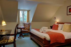 A bed or beds in a room at The Grange at Oborne