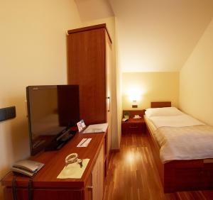 Postel nebo postele na pokoji v ubytování Hotel Penzion Na Hradě