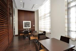 a dining room with wooden walls and tables and chairs at Royal Stays Furnished Apartments - Square One in Mississauga +268 photos