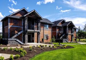 a large house with a lawn at Resort at Eagle Point Golf Club Lodging in Medford