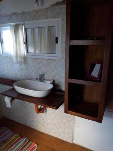a bathroom with a sink and a mirror at Bicicleteria Don Perez in San Isidro +17 photos