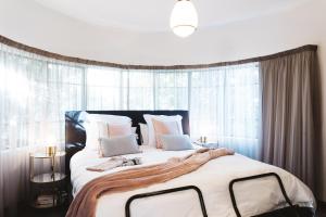 a bedroom with a large bed with a large window at Southlynne in Launceston