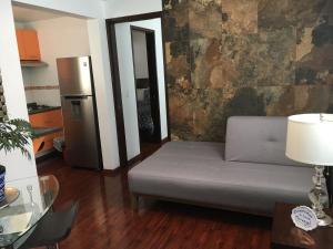a living room with a couch and a refrigerator at Casa Molcajete in Mexico City