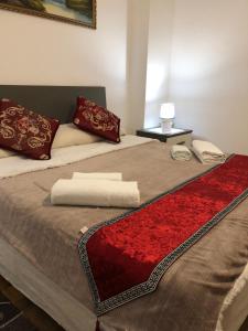 a bed with two pillows and a red rug on it at BB Stay Station in Mestre +66 photos