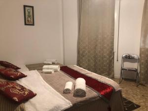 a bedroom with a bed with towels on it at BB Stay Station in Mestre