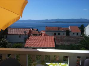 a view of a city from a balcony with an umbrella at Apartments & Rooms Luna in Bol