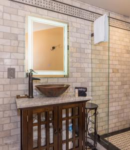a bathroom with a sink and a mirror at 44 Spanish Street Inn (Adults only) in St. Augustine