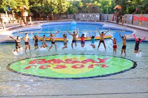 a group of people in the water at a swimming pool at Bosay Resort in Antipolo