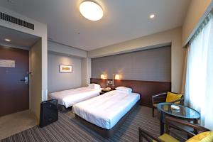 Кровать или кровати в номере Centrair Hotel