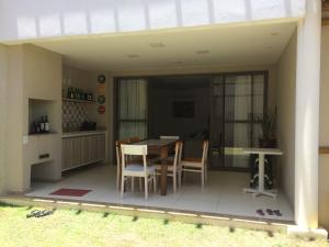 a patio with a table and chairs on it at Village Duplex Confortável e Acolhedor junto a Natureza - Condomínio Reserva das Ilhas in Itacimirim