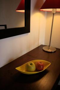 a bowl of fruit sitting on top of a wooden table at Hostal Real in San Juan del Puerto