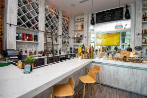a bar with three stools and a counter at LYFE 4111 S Ocean dr in Hollywood