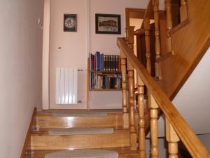 a wooden staircase with a book shelf with books at Apartments Frank in Rovinj