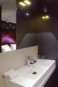 a bathroom with a white sink and a mirror at Blue Mansion Hotel in Aalsmeer