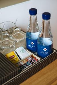 two bottles of water sitting on top of a drawer at Sib Kao in Bangkok