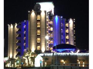 a large building with blue lights on it at night at Hotel ShaSha Toyonaka (Adult Only) in Toyonaka