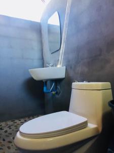 een badkamer met een toilet en een wastafel bij Koh Phaluai Beach Bangalow in Ban Ko Nok Taphao