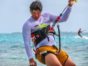 a man is on a surfboard in the water at Gravier beach house in Rodrigues Island