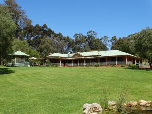 a large building with a grass field in front of it at Pinda Lodge in Margaret River Town