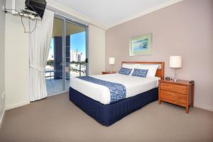 a bedroom with a large bed and a balcony at Pumicestone Blue in Caloundra +84 photos