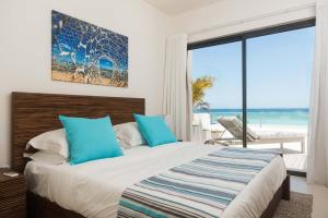 a bedroom with a bed with a view of the ocean at Cap Ouest by Horizon Holidays in Flic-en-Flac