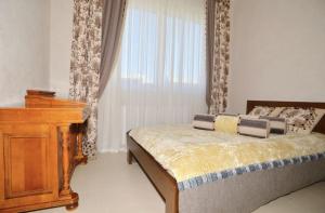 a bedroom with a bed and a dresser and a window at Huge Penthouse with Private Pool in Paphos City