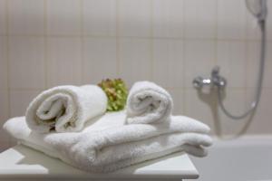 a pile of towels sitting on a counter in a bathroom at Violetos Lux Apartamentai2 in Druskininkai +71 photos