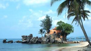 a house on a rocky island in the ocean at Hai Hien Guesthouse in Phú Quốc