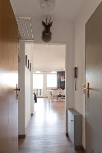 a hallway with white walls and a dining room at Hightop Apartments Winterberg in Winterberg