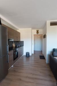 a kitchen with wooden flooring and a long hallway at Hightop Apartments Winterberg in Winterberg