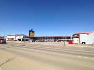 an empty street in front of a shopping center at Galaxy Motel in St. Paul