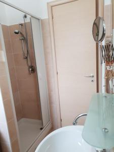 a bathroom with a shower and a white sink at Grazioso Appartamento Vacanze The Lighthouse in Paola