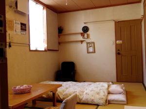 
Tempat tidur dalam kamar di Pension Yumekukan
