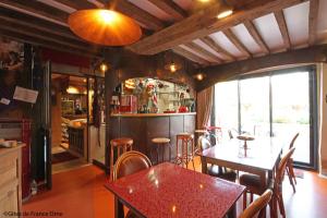 a kitchen and dining room with tables and chairs at Les Insolites de Coco in La Lande-de-Goult +24 photos
