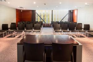 uma sala de conferências com cadeiras pretas e uma mesa em B&B HOTEL Castellón em Castellón de la Plana