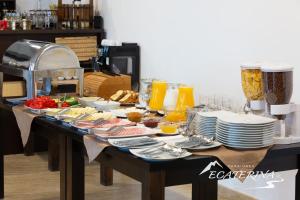 a table with plates and bowls of food on it at Pensiunea Ecaterina in Berzasca +50 photos