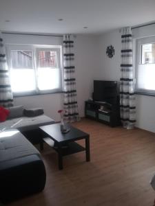 a living room with a couch and a table at Ferienwohnung Burry in Kapellen-Drusweiler
