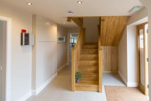a hallway with a wooden staircase in a house at The Dinney Holiday Cottages in Bridgnorth