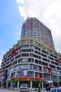 a large building with cars parked in front of it at PM Octagon Ipoh Suites & Apartment 3 in Ipoh