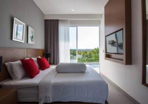 a bedroom with a bed with red pillows and a window at Villa Omah Bali in Uluwatu +43 photos