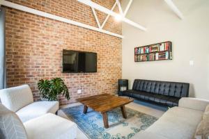a living room with a couch and a table at El Dorado 65 Luxury Self Catering in Oudtshoorn