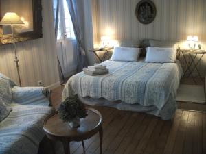 a bedroom with a bed and a couch at Au Fil de l'Aulne in Châteauneuf-du-Faou +17 photos