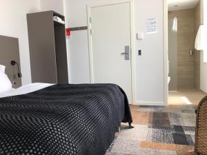 Postel nebo postele na pokoji v ubytování Hotel Skivehus