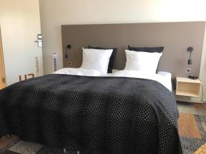 Postel nebo postele na pokoji v ubytování Hotel Skivehus