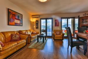 a living room with a couch and a piano at Apartment 365 in Tivat
